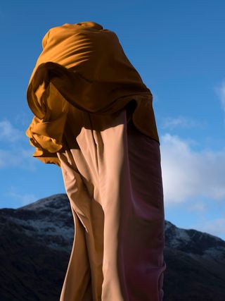 A person wrapped in mustard fabric.