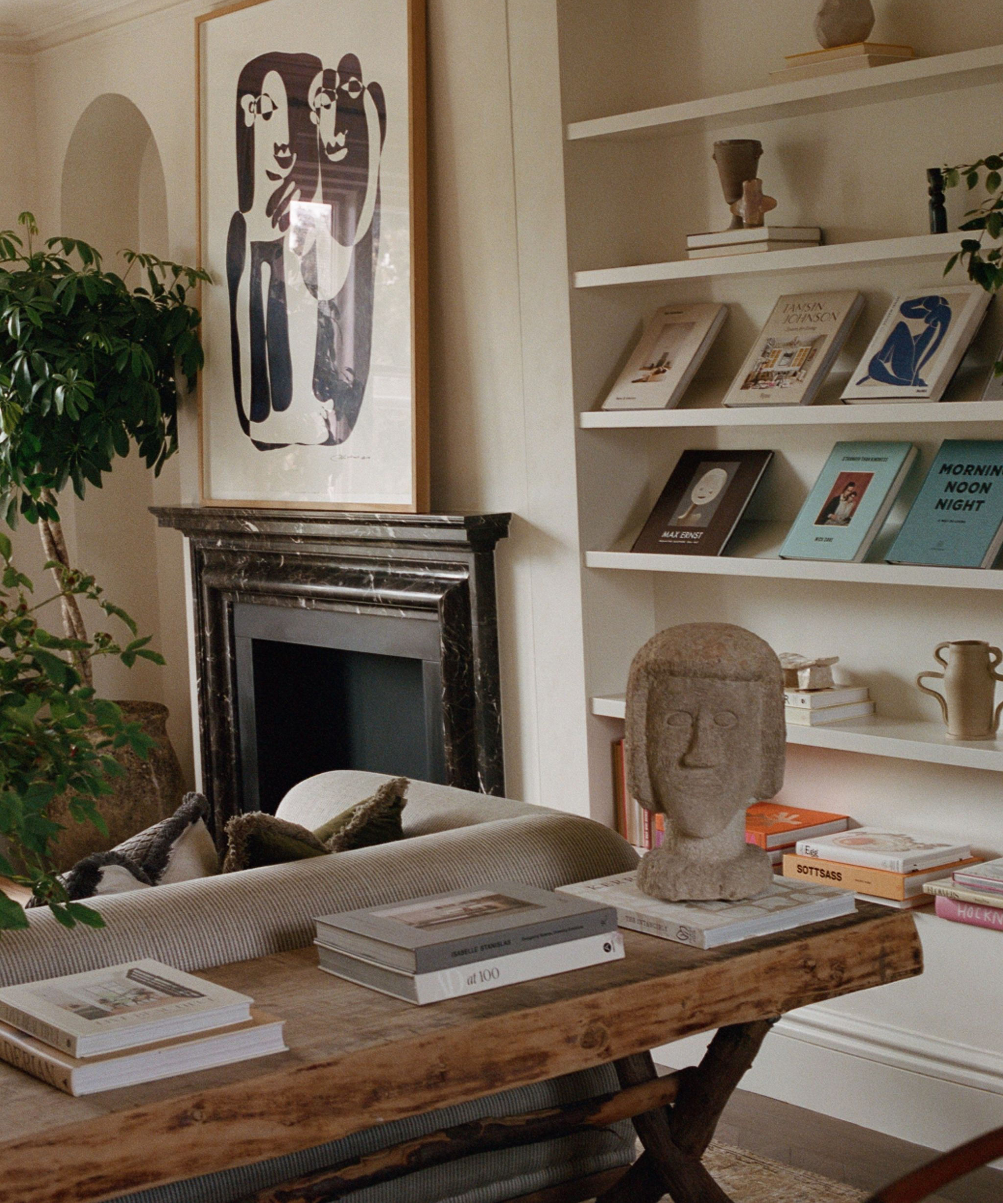 reading corner in a living room with an oak table and coffee table books