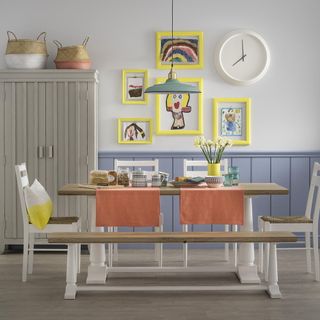 kids room with wooden table bench and artwork on wall