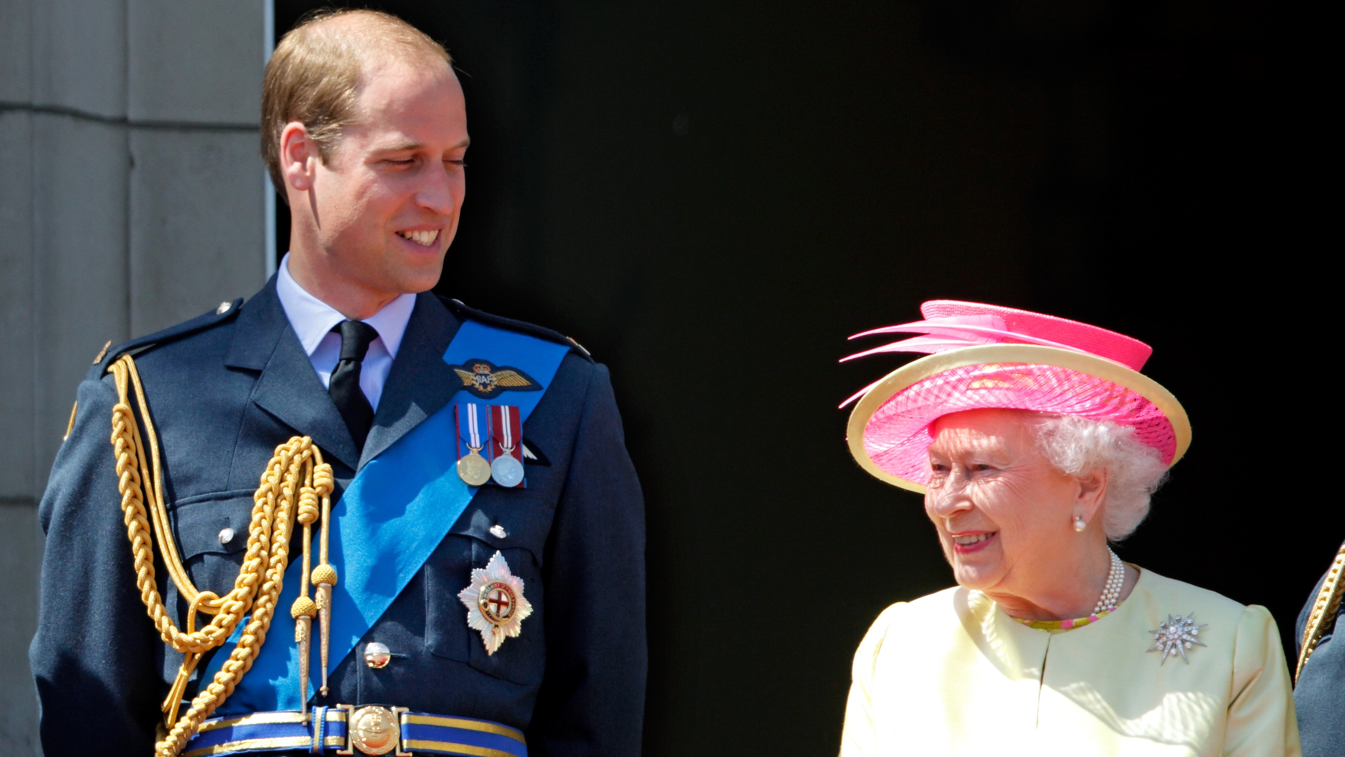 Prince William looks at Queen Elizabeth as they stand on the balcony of Buckingham Palace, commemorating the 75th Anniversary of The Battle of Britain on July 10, 2015