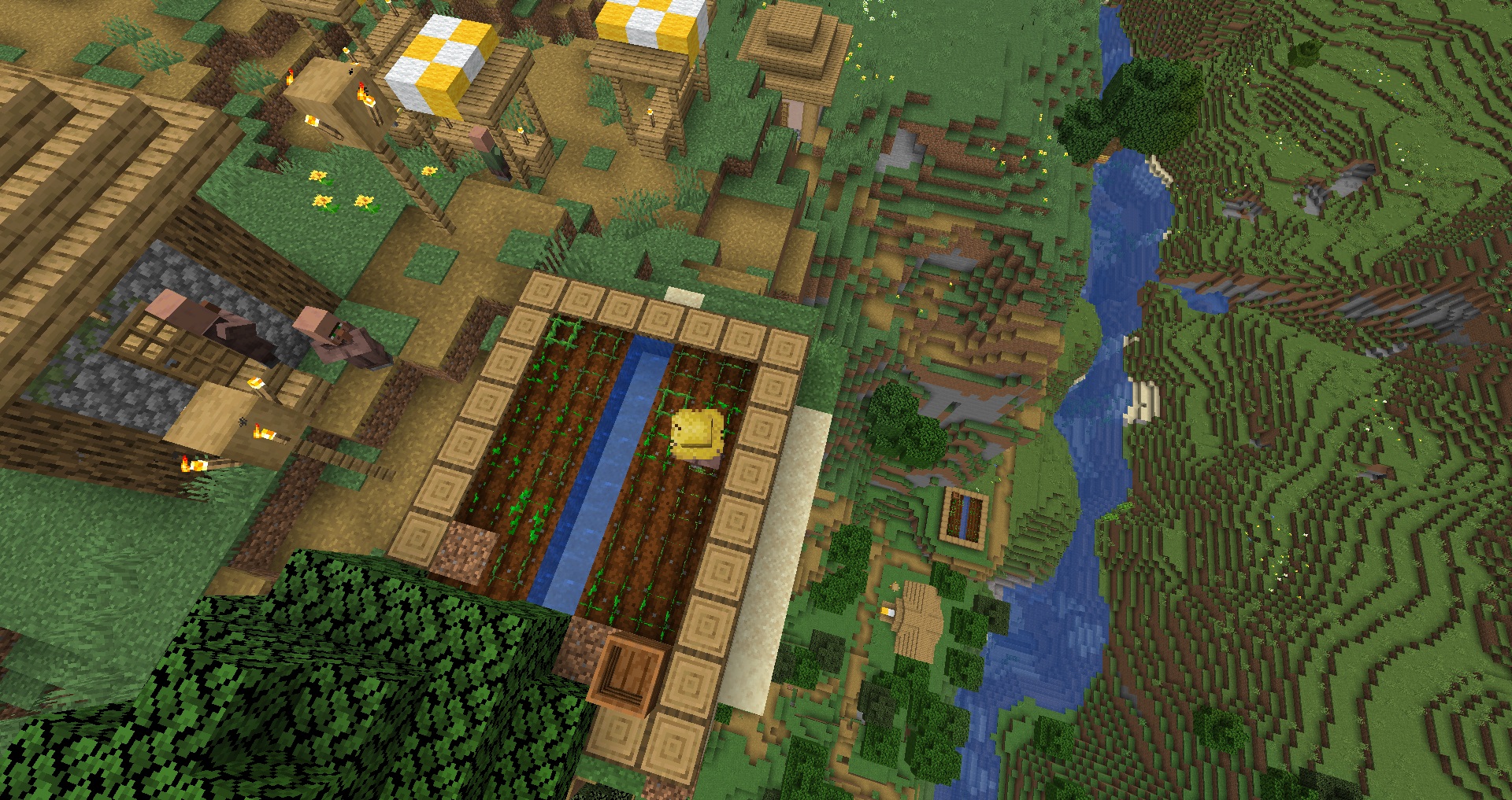 Minecraft - The view from above a village. A farm plot sits at the peak of a plains mountain. Many, many blocks below the rest of the village has spawned near a river.