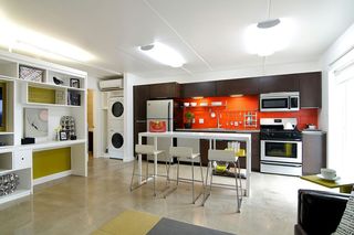 Low-VOC paints and finishes and a concrete floor partner with the updated building envelope to improve and protect indoor air quality in each apartment's kitchen.