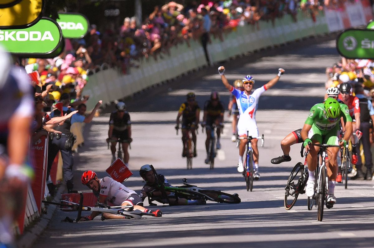 FDJ's Davide Cimolai celebrates the victory as John Degenkolb and Mark Cavendish try to pick themselves up after the crash