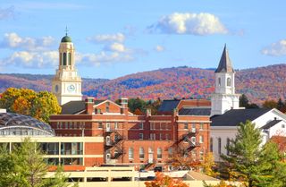 View of Pittsfield, Massachussetts skyline against mountains in fall