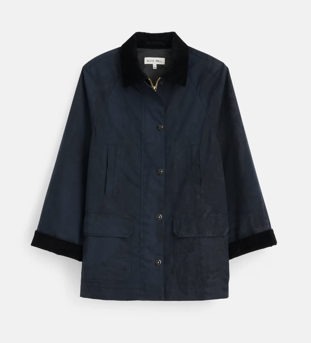 an alex mill barn jacket in front of a plain backdrop