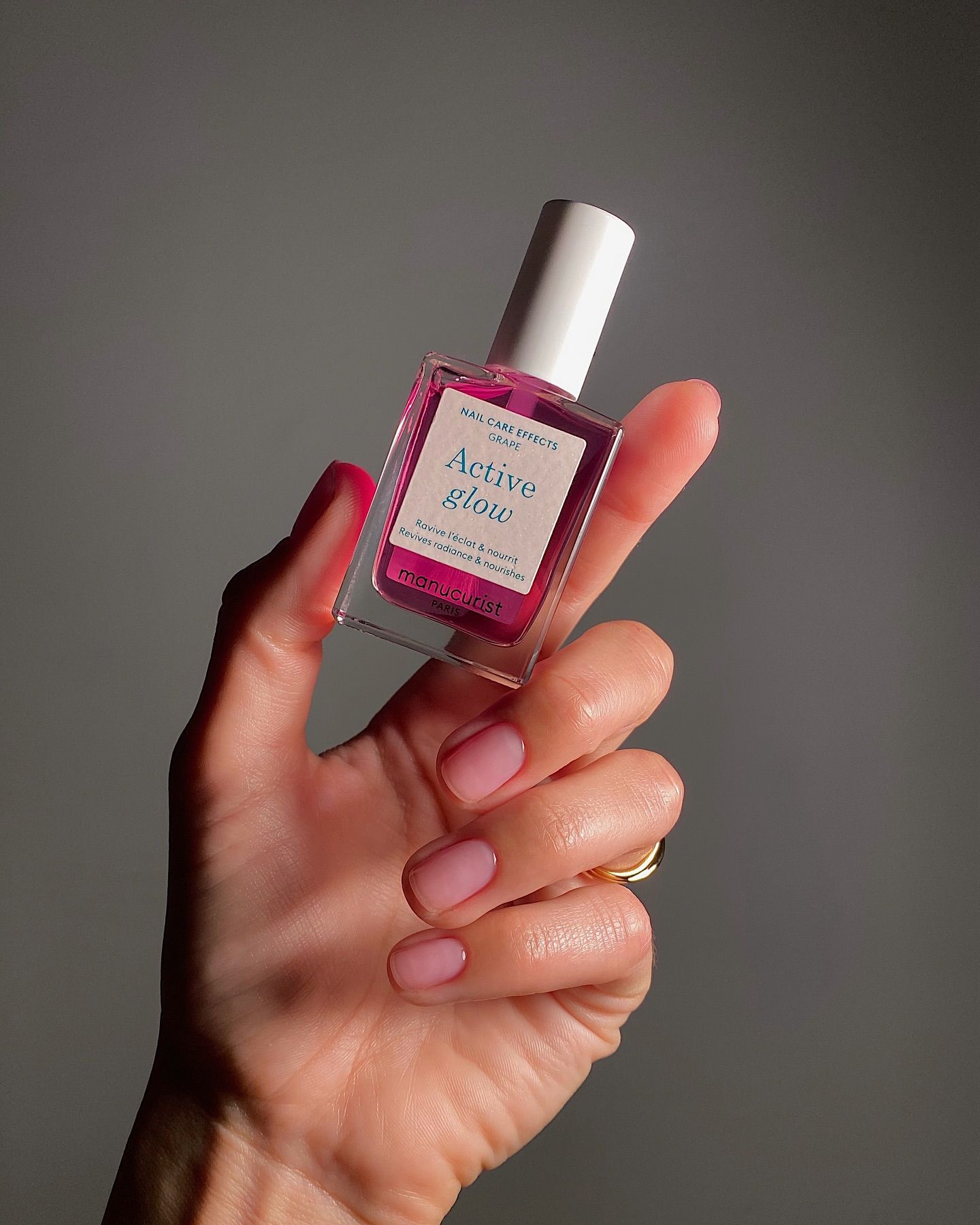 Mate Janova wearing Manucurist Active Glow nail polish in Grape