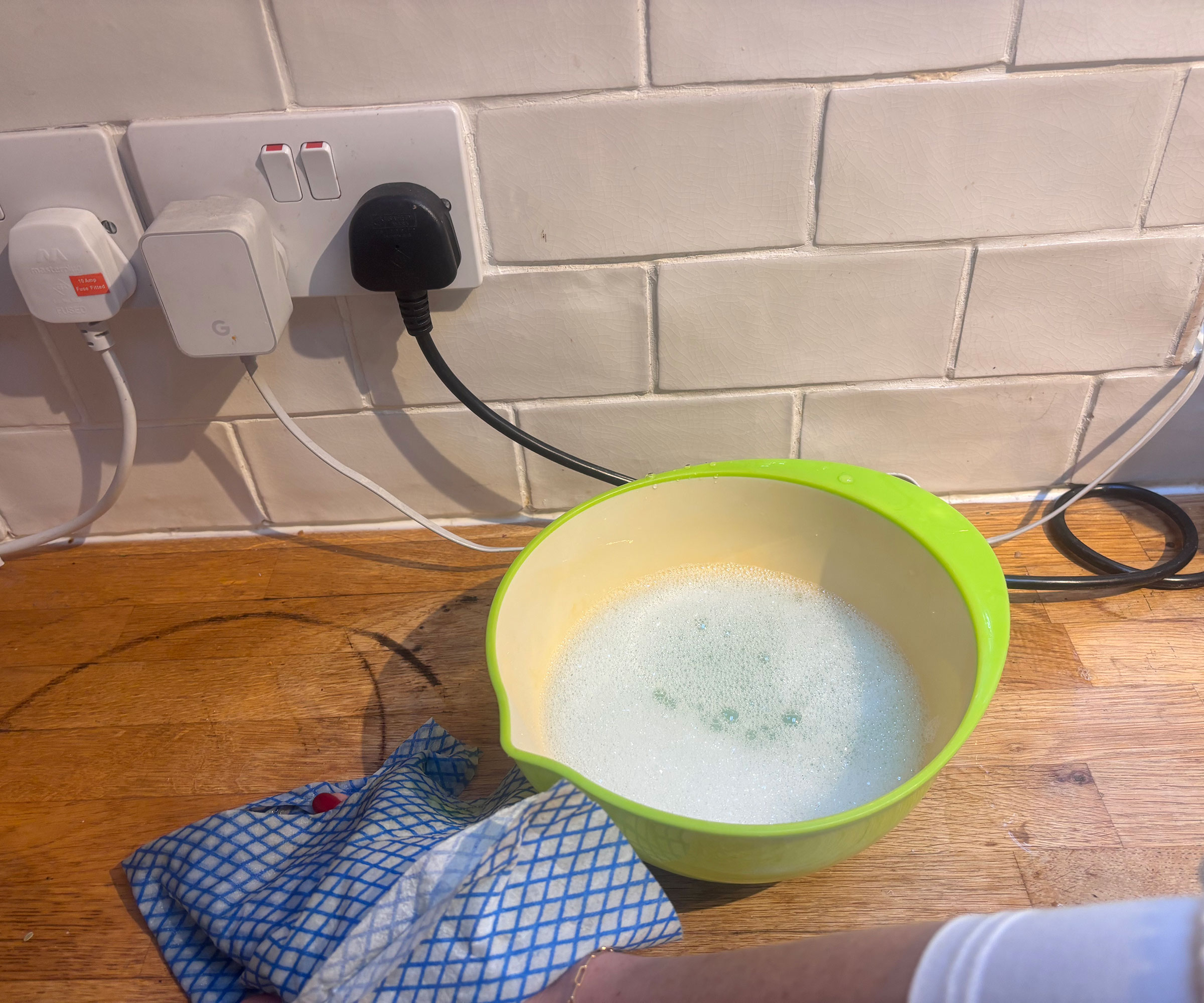 cleaning a wooden worktop with soapy water