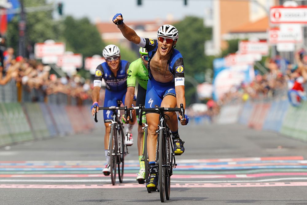 Italy's rider Matteo Trentin celebrates as he crosses the finish line to win the 18th stage of the 99th Giro d'Italia
