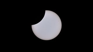 The sun appears to have a "bite" take out of it during the partial solar eclipse.