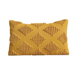 A yellow rectangular accent cushion