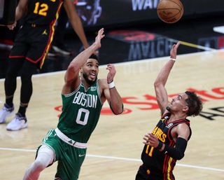 Boston Celtics SF Jayson Tatum attempts to block the shot of Atlanta Hawks PG Trae Young in the second quarter. The Celtics beat the Hawks, 129-121, in Game 4 of their Eastern Conference First Round Series. 