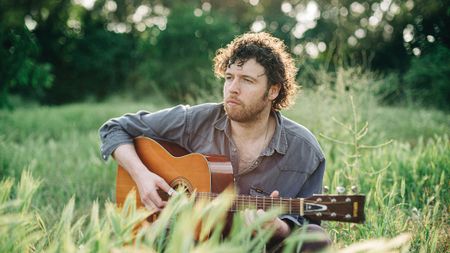 Sam Grassie with his acoustic guitar