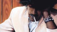 Phil Lynott smoking a cigarette