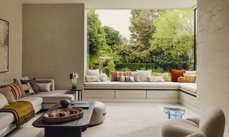 Beige seating area with window seating leading into corner sofa