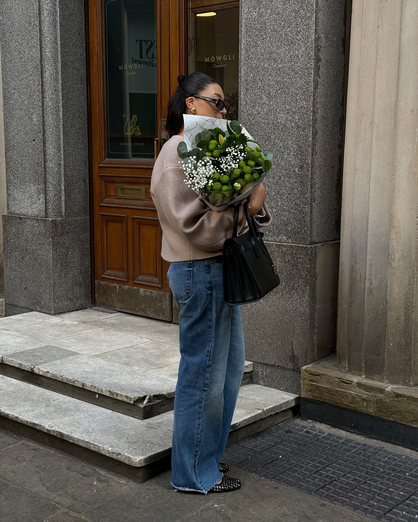 Influencer Tegan Frances wearing an anti-trend outfit of tailored wool jacket, jeans and ballet flats.