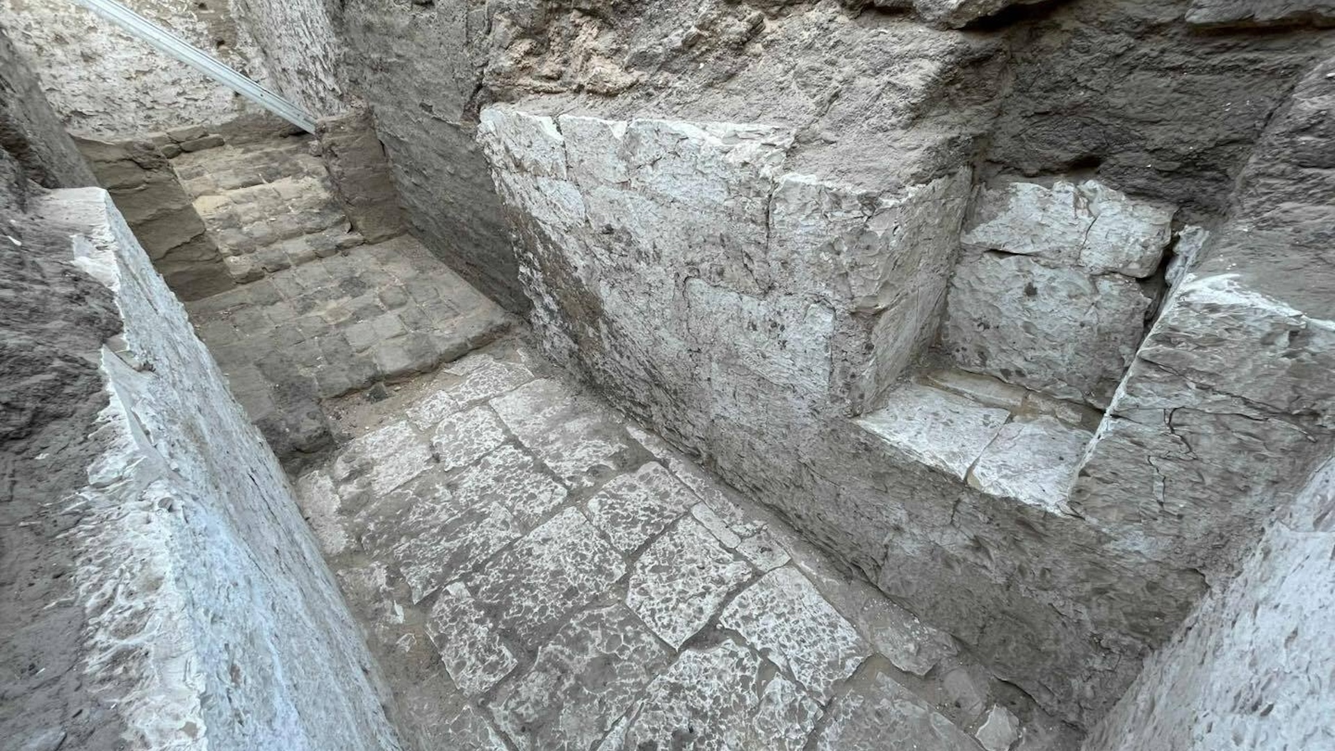 A hallway made of stone blocks in an excavated tomb