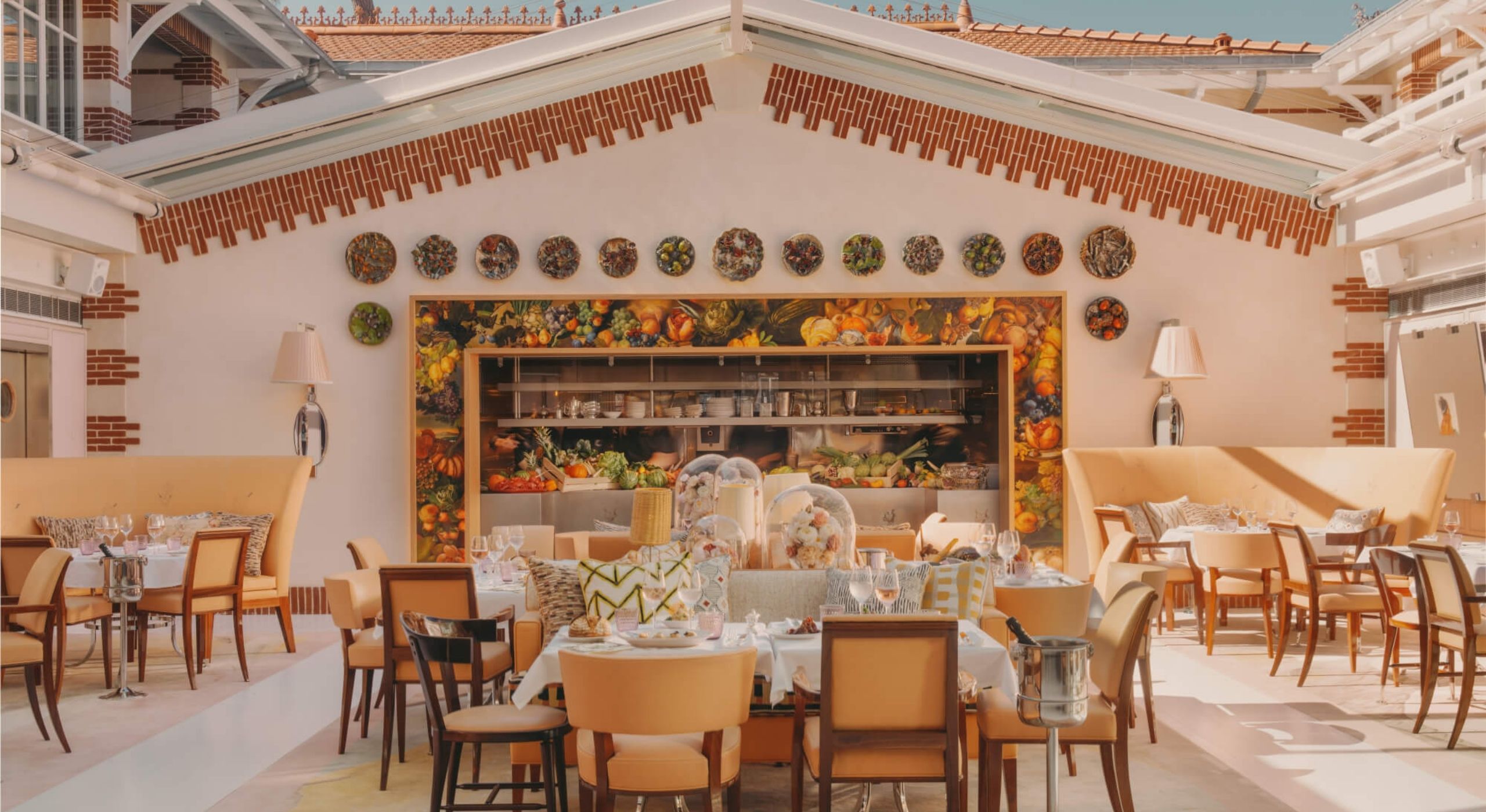 A white-washed coastal hotel boasts Mediterranean decor with minimal lines, occasional splashes of color, plenty of natural linens, plants, and wood accents, and sunshine throughout.