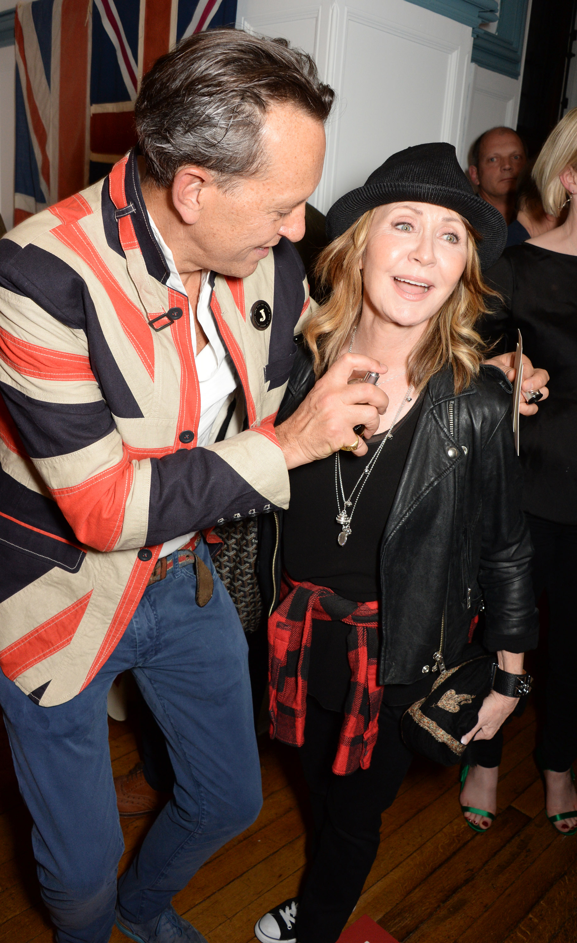 Richard E. Grant spraying Lulu with perfume