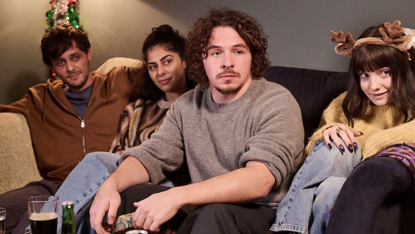 Jake (Tyger Drew-Honey), Rani (Kerena Jagpal), Ben (Daniel Roche) and Karen (Ramona Marquez) sitting together in the Outnumbered 2024 Christmas Special 