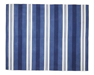 A blue and white striped outdoor rug