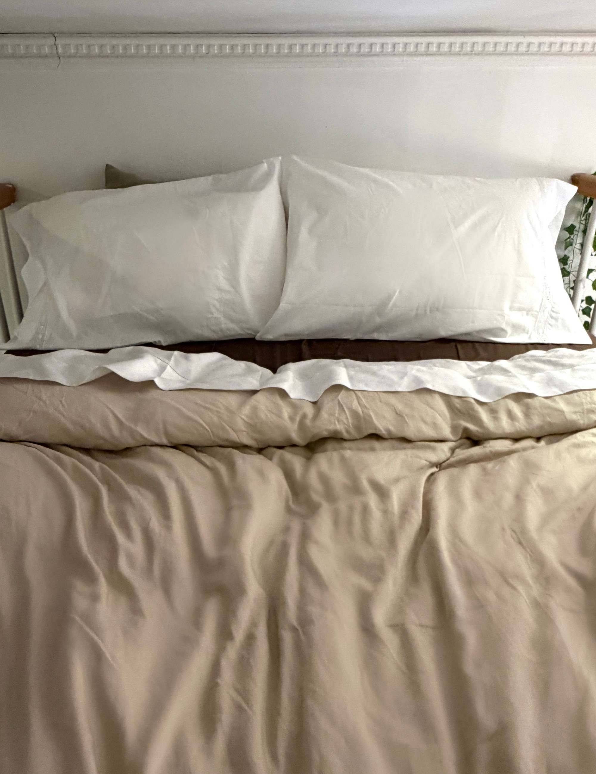 Sferra Giza 45 Sateen bed sheets styled in a lofted NYC bedroom