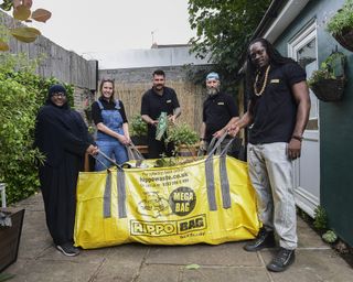 A group of gardeners in front of a Hippo waste removal sack