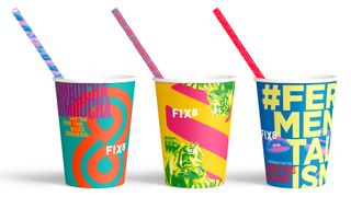 three brightly coloured cups with straws