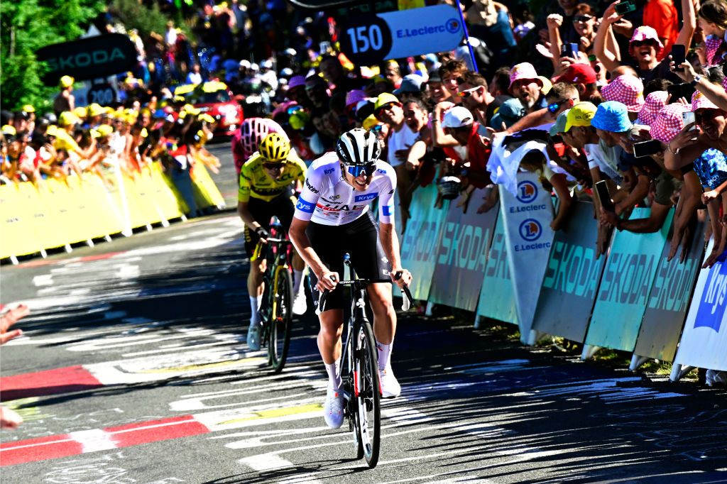 GRAND COLOMBIER FRANCE JULY 14 Tadej Pogacar of Slovenia and UAE Team Emirates White Best Young Rider Jersey R attacks to Jonas Vingegaard of Denmark and Team JumboVisma Yellow Leader Jersey in the final kilometres of the climb to the Grand Colombier 1501m while fans cheer dduring the stage thirteen of the 110th Tour de France 2023 a 1378km stage from ChtillonSurChalaronne to Grand Colombier 1501m UCIWT on July 14 2023 in Grand Colombier France Photo by Bernard Papon PoolGetty Images