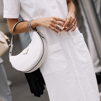 woman in white wearing prada bag
