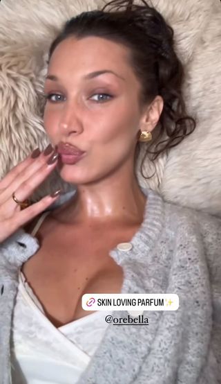 A photo of Bella Hadid sporting the '80s gold jewelry trend in a pair of textured oversize studs.