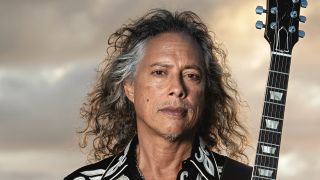 Kirk Hammett holding his guitar to the camera