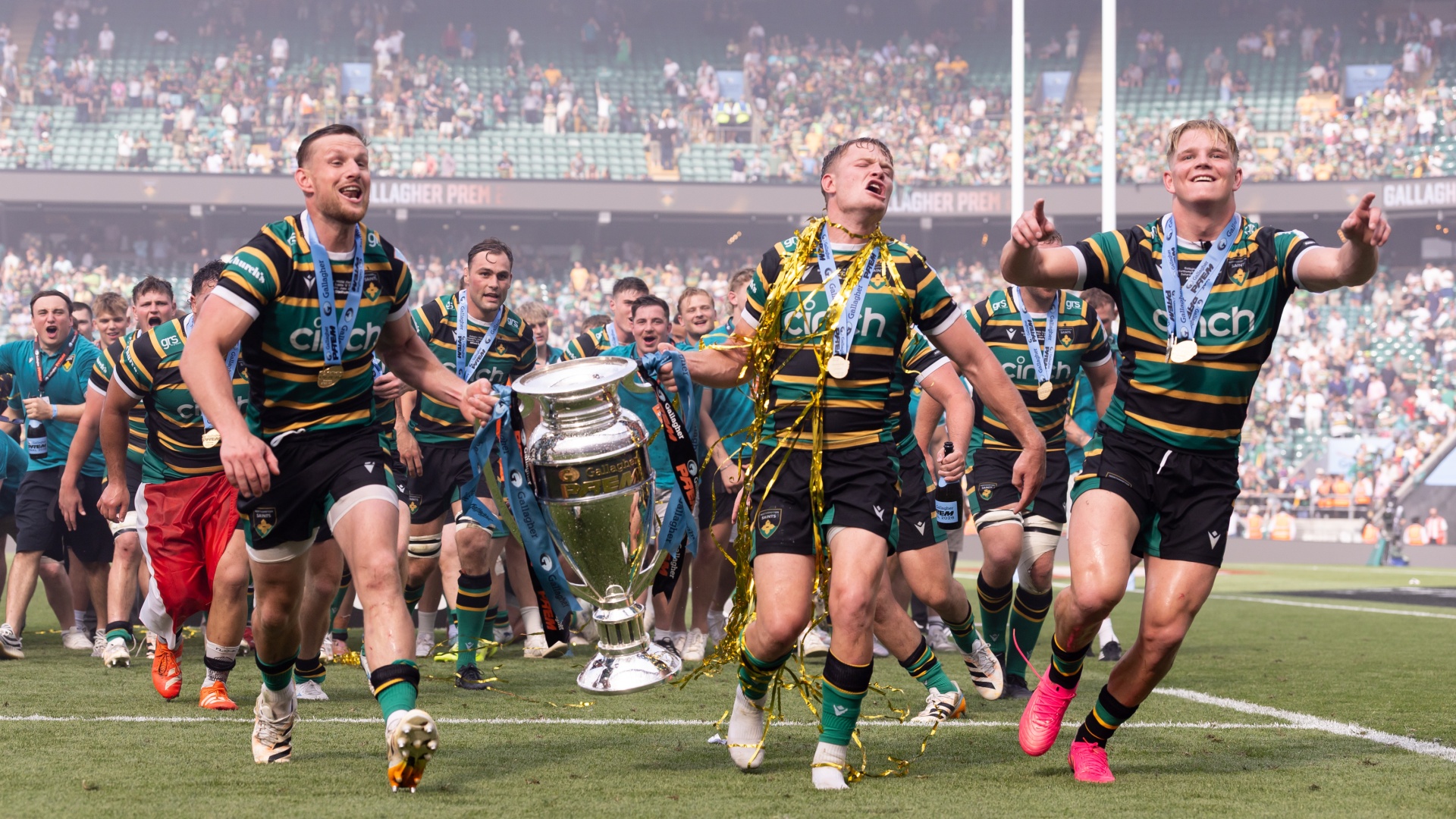 Fraser Dingwall, Fin Smith and Henry Pollock of Northampton Saints celebrate winning the Gallagher PREM Rugby title on June 20, 2026