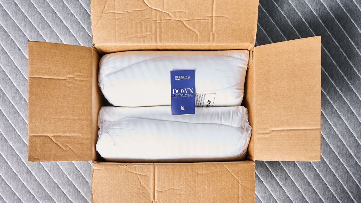 Beckham Hotel Collection Down-Alternative Pillows rolled up inside the box