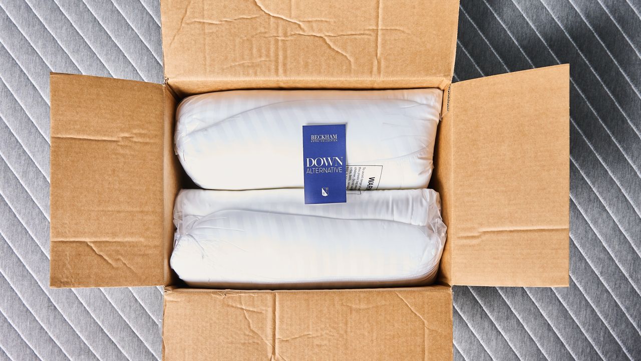 Beckham Hotel Collection Down-Alternative Pillows rolled up inside the box