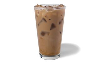 A tall glass with Starbucks Blonde Iced Vanilla Latte - a brown liquid with ice