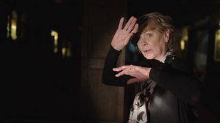 Judith (Samantha Bond) holds her hand up to the light in The Marlow Murder Club.