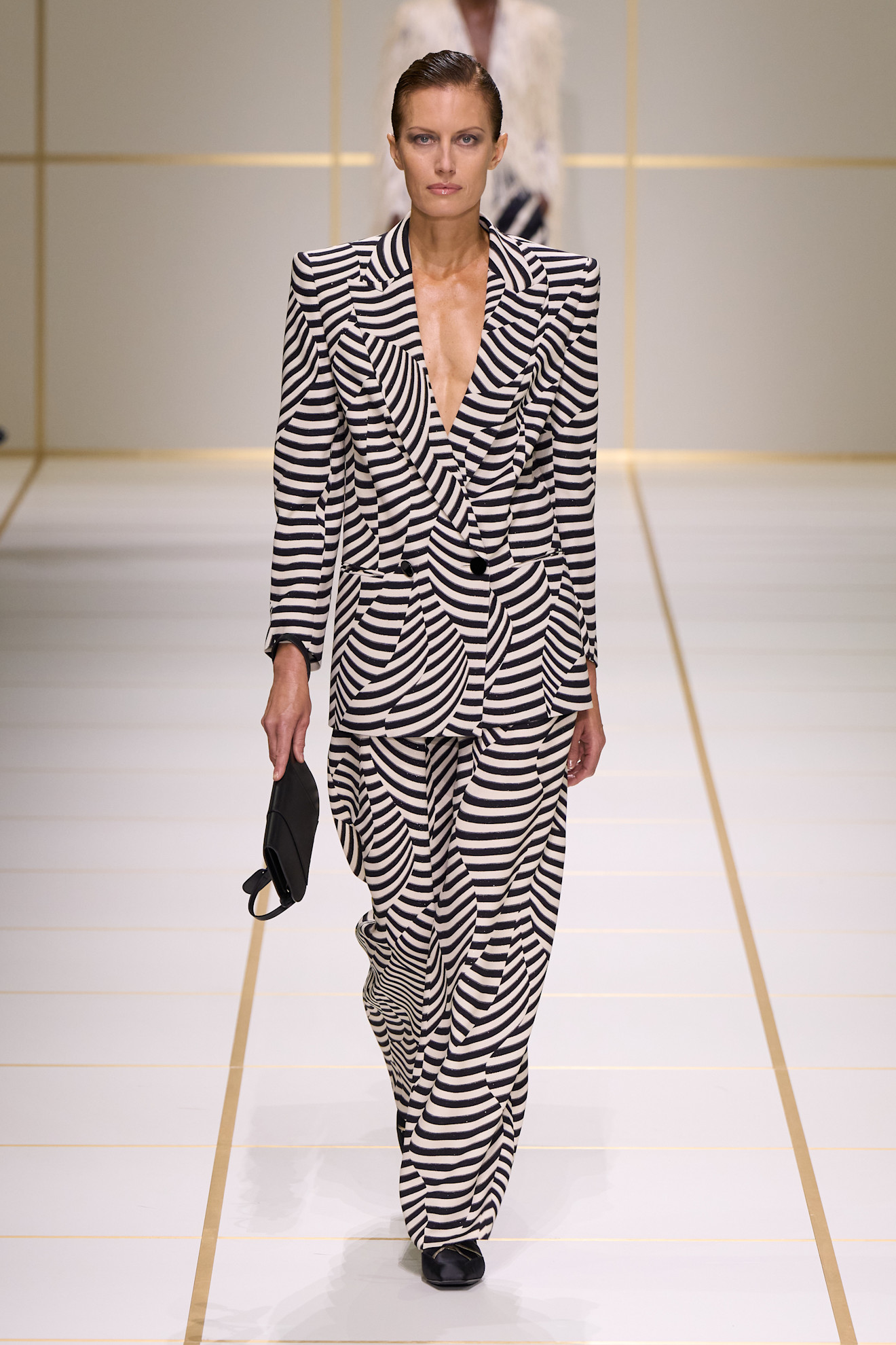 A model walks the giorgio armani s/s 27 runway.