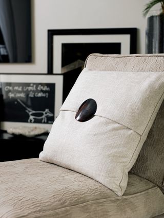 cream cushion with black bone button