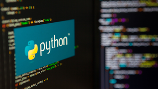 The Python banner logo on a computer screen running a code editor.
