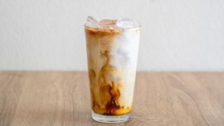 an iced coffee on a wooden countertop