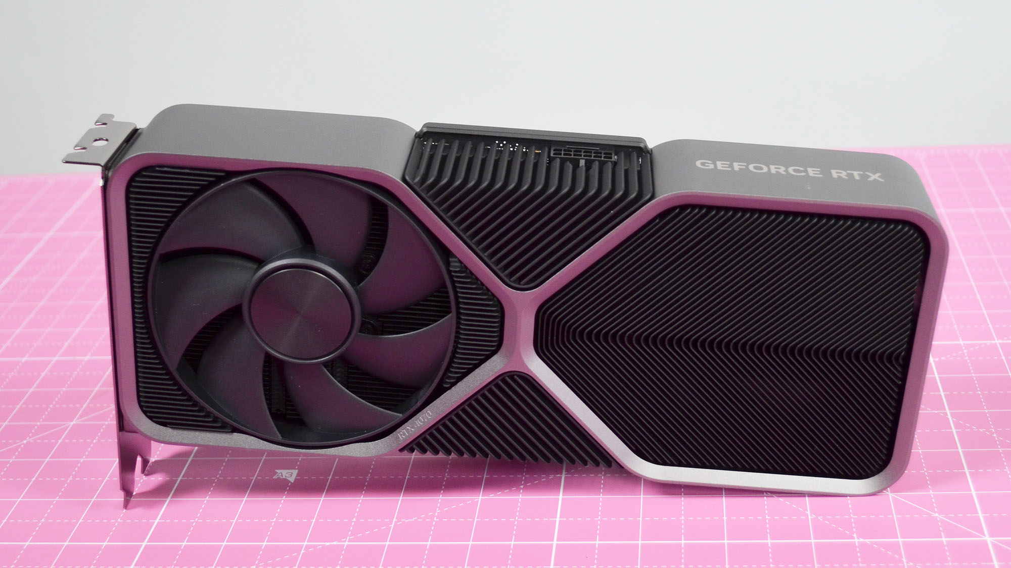 An Nvidia GeForce RTX 4070 graphics card on a pink desk mat