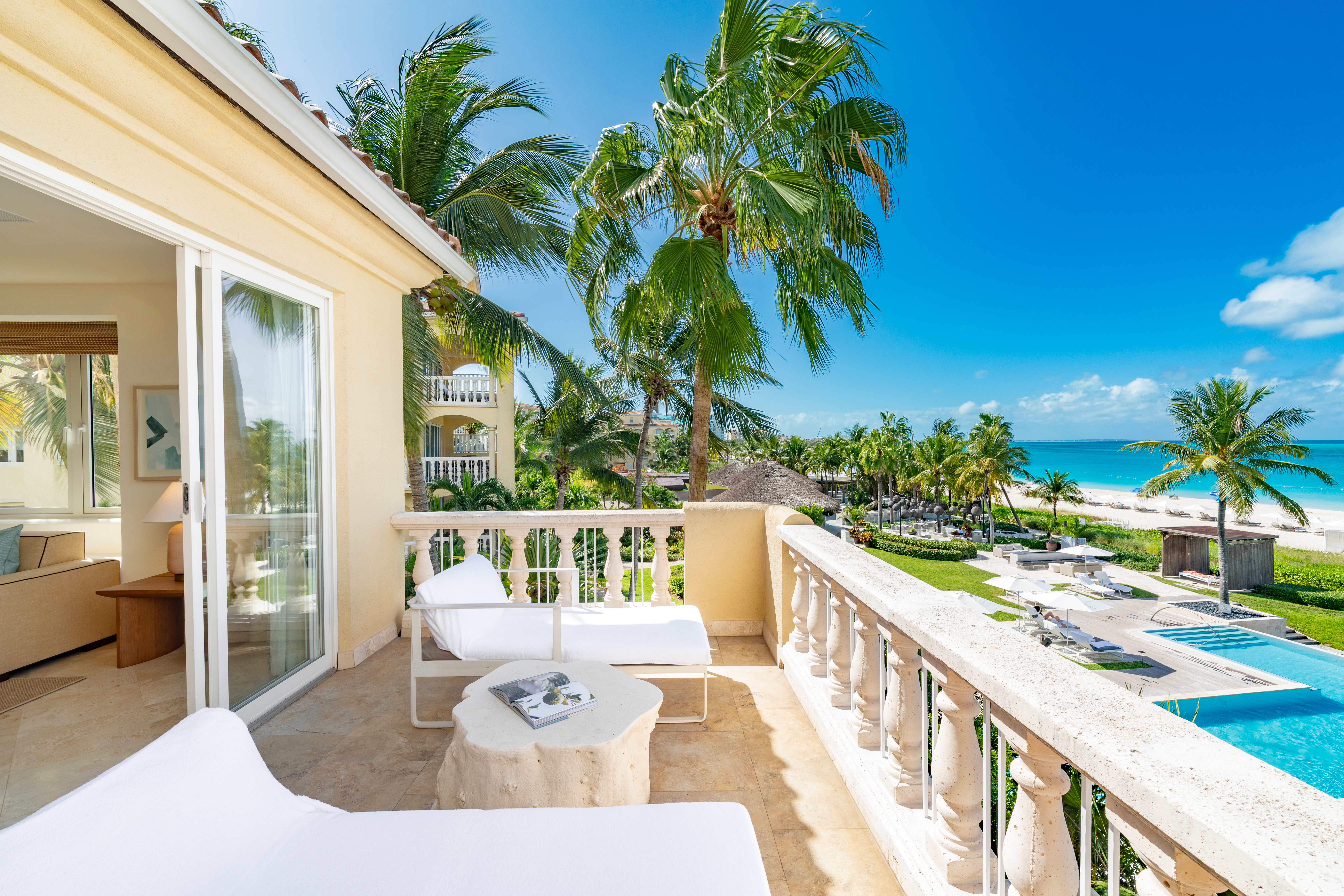 The ocean and pool view from a balcony at Grace Bay Club