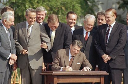Ronald Reagan signs his landmark tax overhaul into law in 1986.