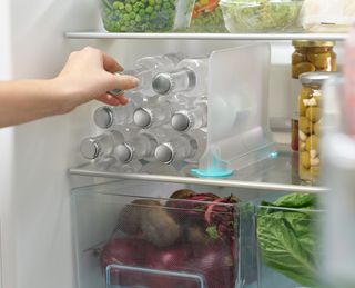 an organized fridge with storage drawers and dividers