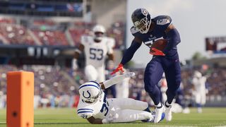 An image of Madden NFL 23, showing one player collapsed on the ground while another stands over him.