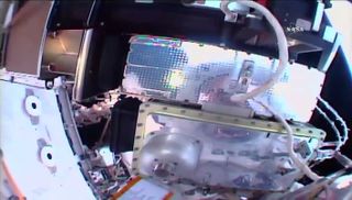 NASA astronaut Joe Acaba installed a new HD camera on the space station's starboard truss, his helmet camera caught his reflection in the shiny new equipment.