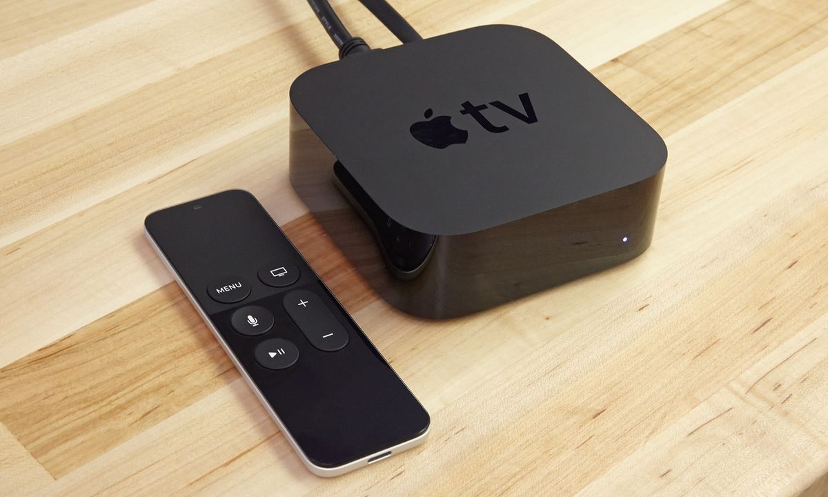 A photo of the Apple TV HD on a table with its remote