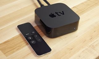 A photo of the Apple TV HD on a table with its remote