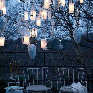candle holder with white chair and hanging lights