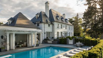 House exterior with pool and pool house